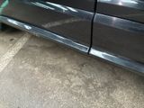 a black car parked on the side of the street