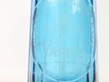 a blue glass vase with a blue lid on a white background