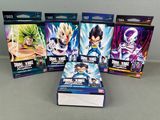 five dragon ball trading cards in a row on a table