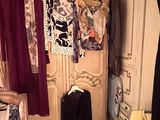 an image of a closet with clothes hanging on it