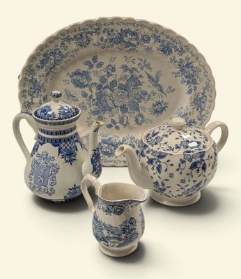 three pieces of blue and white china on display
