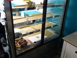 a display case with donuts in it in a bakery