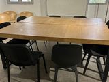 tables and chairs in a room with a whiteboard on the wall