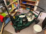 a green lawn mower sitting on the floor in a room