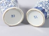 pair of blue and white vases sitting on top of a white table
