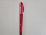 a red pen sitting on top of a white surface