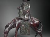 bronze statue of a man riding a horse with a hat on his head