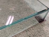 a glass table with a glass top on the floor