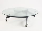 a glass coffee table with wheels on a white background