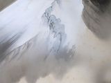 a snow covered mountain in the middle of a cloud filled sky