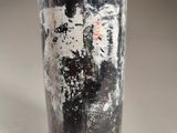a bottle that has a lot of dirt on it