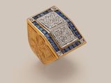 a close up of a gold and diamond ring with blue sapphires