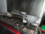 a stove with a pan on top of it in a kitchen