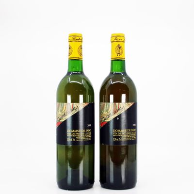 two bottles of wine sitting next to each other on a white surface