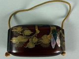 an image of a brown purse with a flower design on it