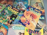 a lot of comic books on the table together