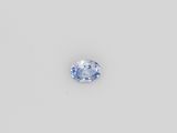a blue sapphire stone on a white surface