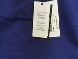 a close up of a blue shirt with a tag on it