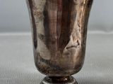 a silver cup that is sitting on a table