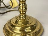 a gold candle that is sitting on a white table