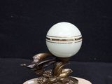 a white egg sitting on top of a marble base