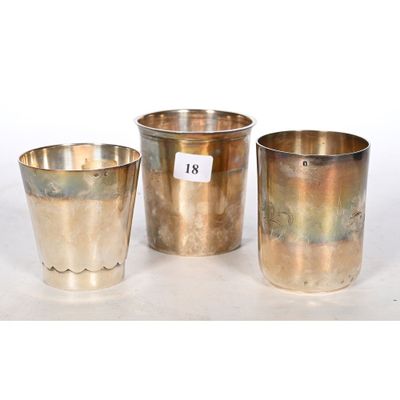 three silver cups and a silver cup with a price tag