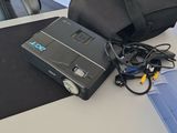 a bag sitting on top of a table next to a laptop