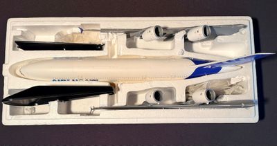 a model of an airplane in a plastic box