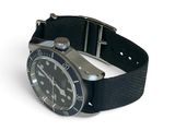 a black watch with a black band on a white background