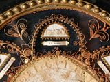 a close up of a decorative clock with gold decorations on it