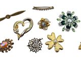 many different types of brooches and brooches on a white background