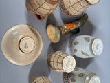 many cups and saucers arranged in a circle on the wall