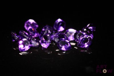 purple amethorate gems on a black background