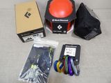 a box of items that include a red ball, a black bag, and a pair of scissors