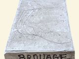 a close up of a concrete block with the word bruvage written on it