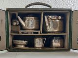 a green case with silverware in it on a table