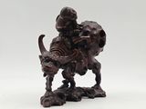 an old wooden statue of a man on a horse with a skull