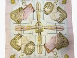 pink and gold silk scarf with purses and purses on it