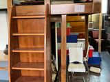 a bunk bed with a ladder in the middle of a room