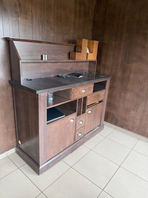a small kitchen with a wooden cabinet and a sink