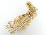 a close up of a gold and diamond broochle