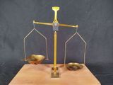 an image of a scale with two spoons and a bowl on it