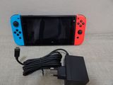 a nintendo switch lite with a charger attached to it