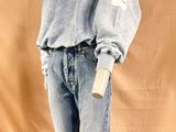 an image of a mannequin wearing a blue sweater and jeans