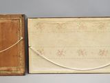 an old wooden box with a closed door and a rope hanging from it