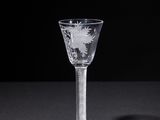 a wine glass that is sitting on a table