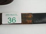 a knife that is laying on a table next to a cup