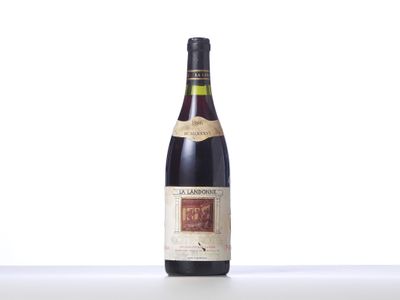 a bottle of wine sitting on top of a white table