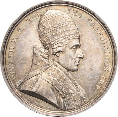 une vieille pièce d'argent à l'effigie d'un homme coiffé d'une couronne
