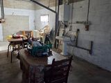 a room with a table, chairs, and a machine in it